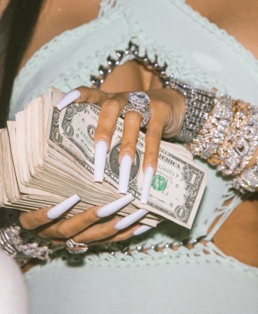Money in celebrities hands at Booby Trap On the River